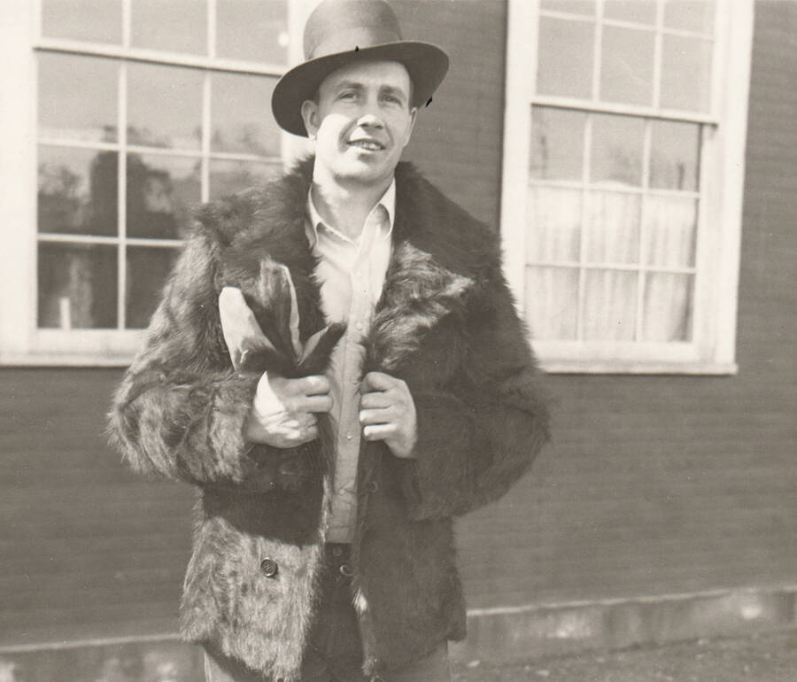 Man models of cowhide coat with cow hair still attached. Note: This image is part of a Work Progress Administration publicity series.