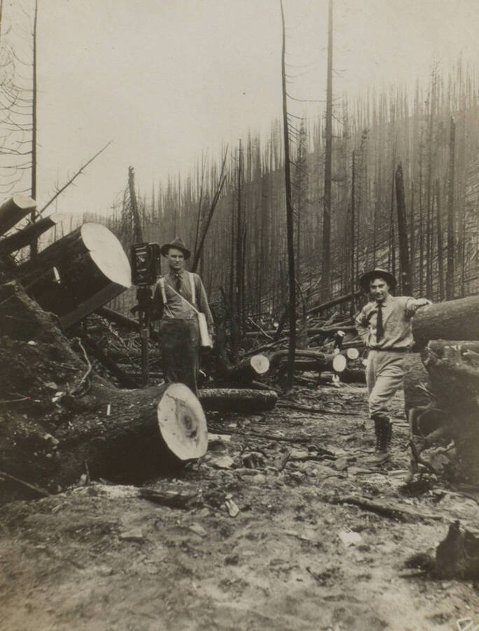 Photo text: 'The trail crews worked under difficulties.' This image is part of a pictorial narrative by William W. Morris titled 'Experiences on a National Forest'.
