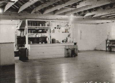 Photo text: 'Camp and construction scenes at Wallace Flood Camp to dredge and straighten channel of Coeur d'Alene River. Single men's camp.' Note: This image is part of a Work Progress Administration publicity series.