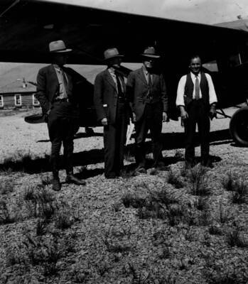 Photo text: 'Foresters-at-work. Assistant Chief Granger, C.N. Woods, W.B. Rice, and pilot H.M. Walker after 2 hour trip over Idaho Primitive Area.'