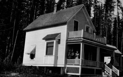 Photo text: 'Pend d'Oreille National Forest, Idaho. -- Home of an enterprising rancher on the Forest, with dense stand of silver pine in the background.'