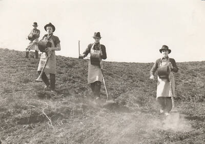 Four men with crank apparatuses dust a field with insecticide for Mormon Crickets, Ada County. Note: This image is part of a Work Progress Administration publicity series.
