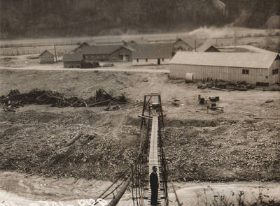 Photo text: 'Camp and construction scenes at Wallace Flood Camp to dredge and straighten channel of Coeur d'Alene River. Single men's camp.' Note: This image is part of a Work Progress Administration publicity series.