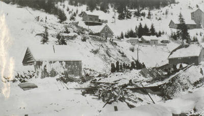 Photo text: 'Those who had been unfortunate enough to locate at the mouth of these draws were first awakened by a great roar only to be buried under tons of snow seconds later.' This image is part of a pictorial narrative by William W. Morris titled 'Experiences on a National Forest'.
