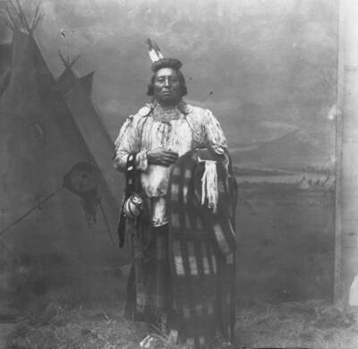 Glass negative of Chief Wolf Necklace in traditional dress. Print is labeled as 'Paloos' also spelled 'Palus'.
