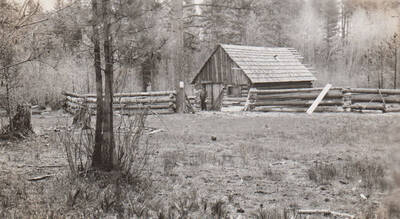 Photo caption: 'Art McConville lives in this cabin. It is located on the Tribal Reserve which he has leased, and he is farming 125 acres of Tribal land.' This image is part of a report regarding farm organizations among tribes in Northern Idaho and the CCC-Indian Division.