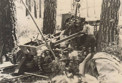 Photo text: 'Nez Perce Reservation. Enrollees Oliver Henry and James Taylor working on tractor [bulldozer].' Note: This image is part of a narrative pictoral report to accompany quarterly enrollee program report.