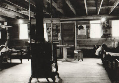 Photo text: 'Camp and construction scenes at Wallace Flood Camp to dredge and straighten channel of Coeur d'Alene River. Single men's camp.' Note: This image is part of a Work Progress Administration publicity series.