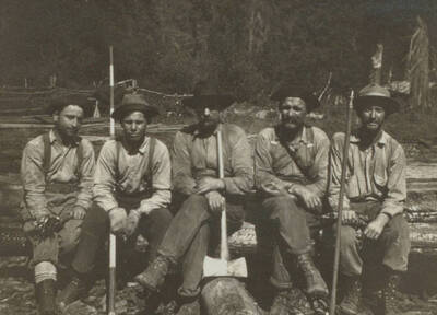 Photo text: 'Timber cruisers on the North Fork. Morris and Bruce on either end.' This image is part of a pictorial narrative by William W. Morris titled 'Experiences on a National Forest'.