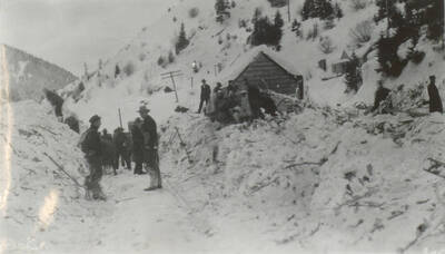 Photo text: 'The Burk Canyon is only a few hundred feet wide. Pulaski and Halm in the foreground.' This image is part of a pictorial narrative by William W. Morris titled 'Experiences on a National Forest'.