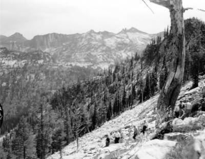 Photo text: 'Teacher group on Maude Creek Trail - Through rock field to Big Creek Lake - In Wilderness area.' This image is part of a series recording trail work and outdoor education in the Bitterroot National Forest.