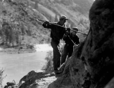 Civilian Conservation Corps workers constructing a road on the Salmon River above French Creek in the Salmon-Challis National Forest.