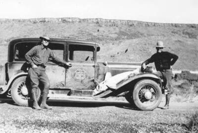 Photo text: 'The Leader and Tom Ledbetter displaying a sturgeon, Idaho's big native fish from the Snake River.' This image is part of a report by the United States Department of Agriculture Biological Survey on predation and pests.