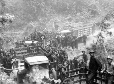 Photo text: 'CCC boys leaving trucks in the early morning for work on fire line. Pack River Fire.'