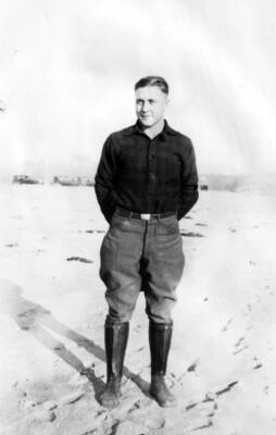 Photo text: 'Frank Keough, Cooperative Trapper, Clearwater River, 1935. He seems to make a very good impression with the ladies as well as the predatory animals.' This image is part of a report by the United States Department of Agriculture Biological Survey on predation and pests.