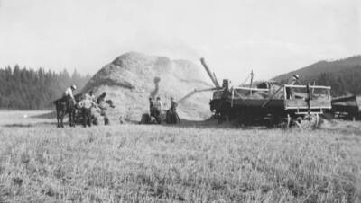 Threshing crew and barley harvest. This image is part of a report regarding farm organizations among tribes in Northern Idaho and the CCC-Indian Division.