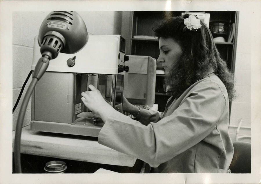 Woman operating some type of scientific equipment