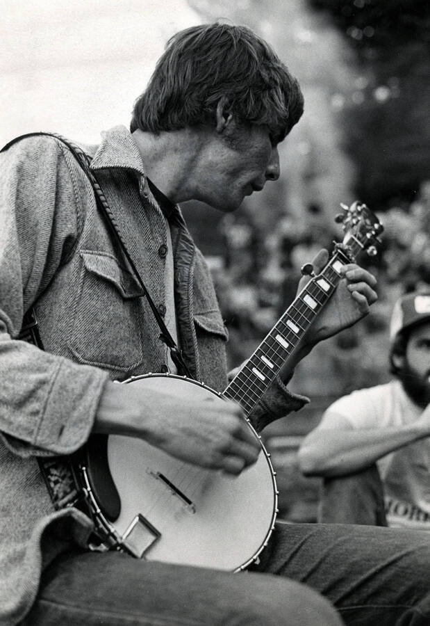 A student singing and playing the banjo.