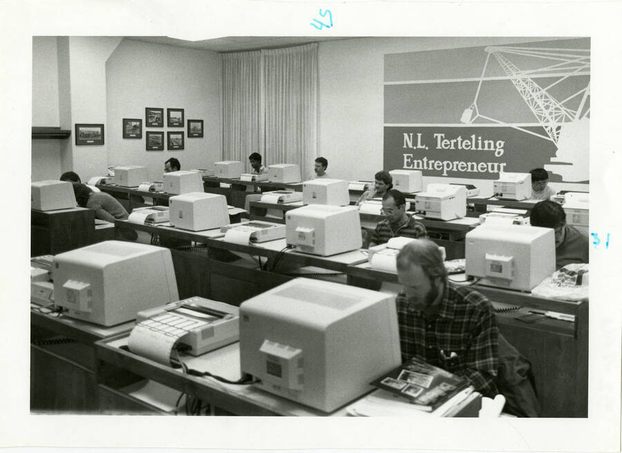 Students sitting at computer stations in a computer lab labeled ""N.L. Terteling Entrepreneur.""