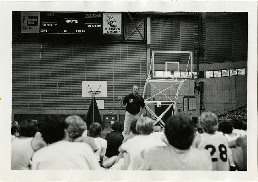 Don Monson talking to basketball players at summer basketball camp.