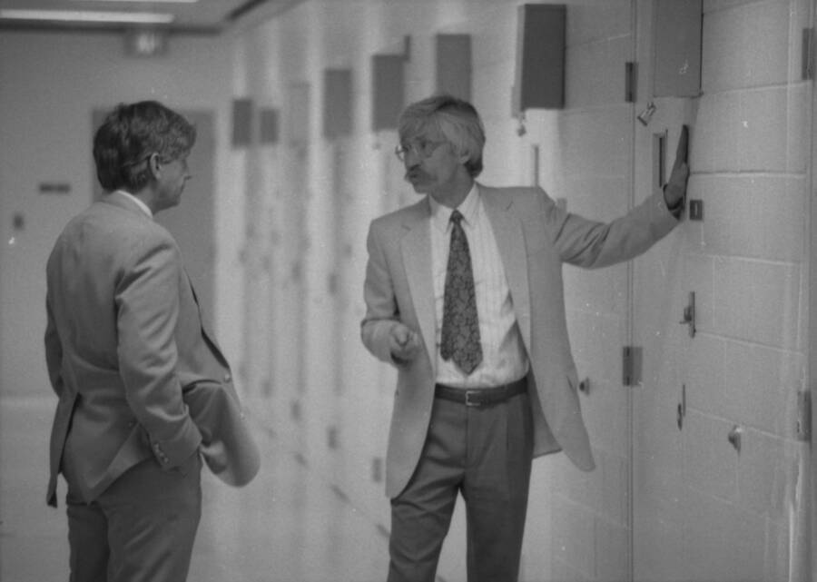 Two men talking in a hallway.