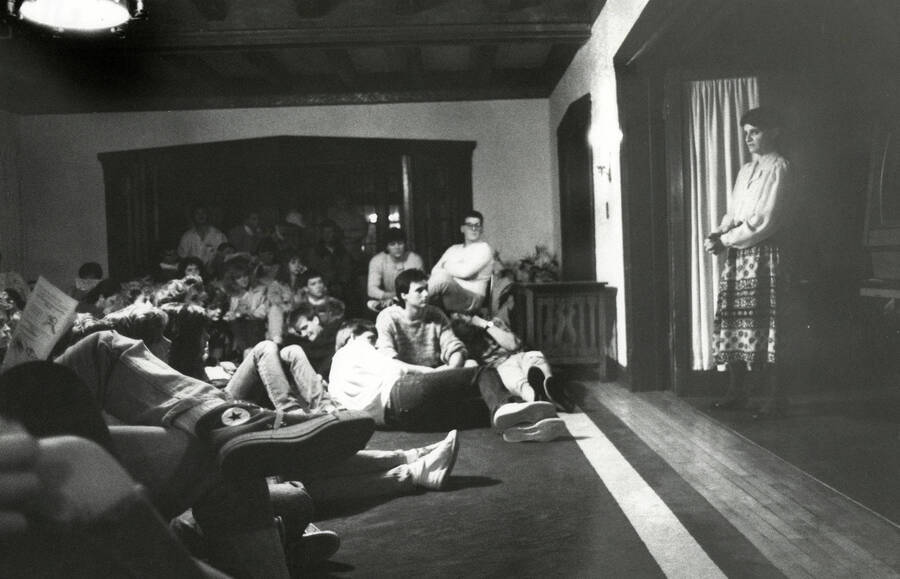 Woman on stage in front of audience.