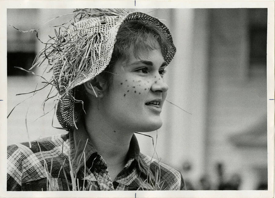 Theater student in costume of possibly either a farm girl/boy or a scarecrow.