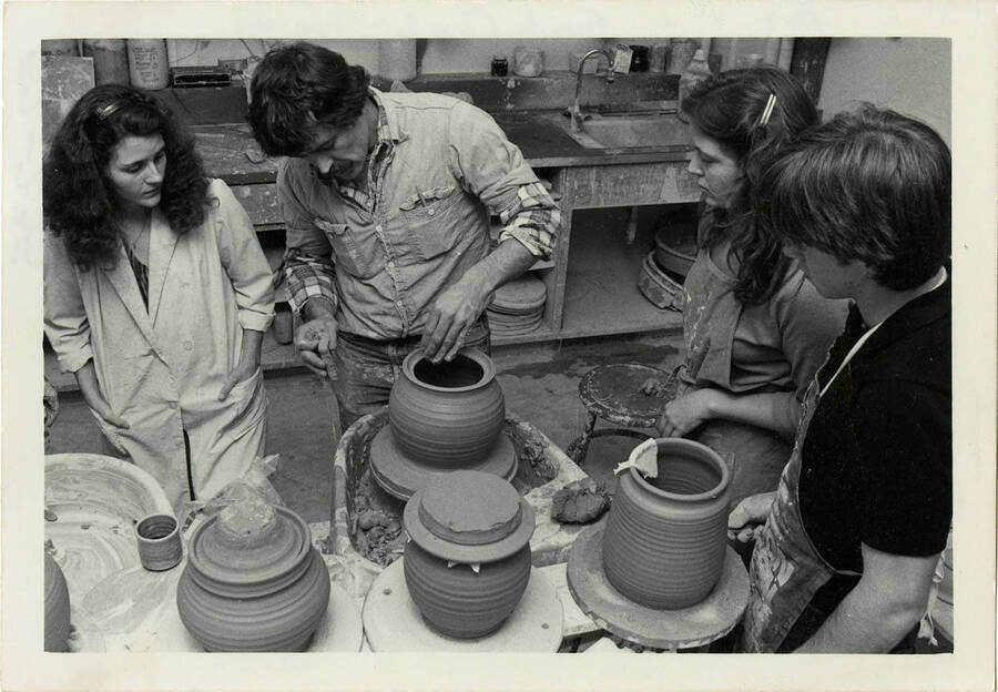 Students watch Professor Frank Cronk in a pottery class at the University of Idaho.
