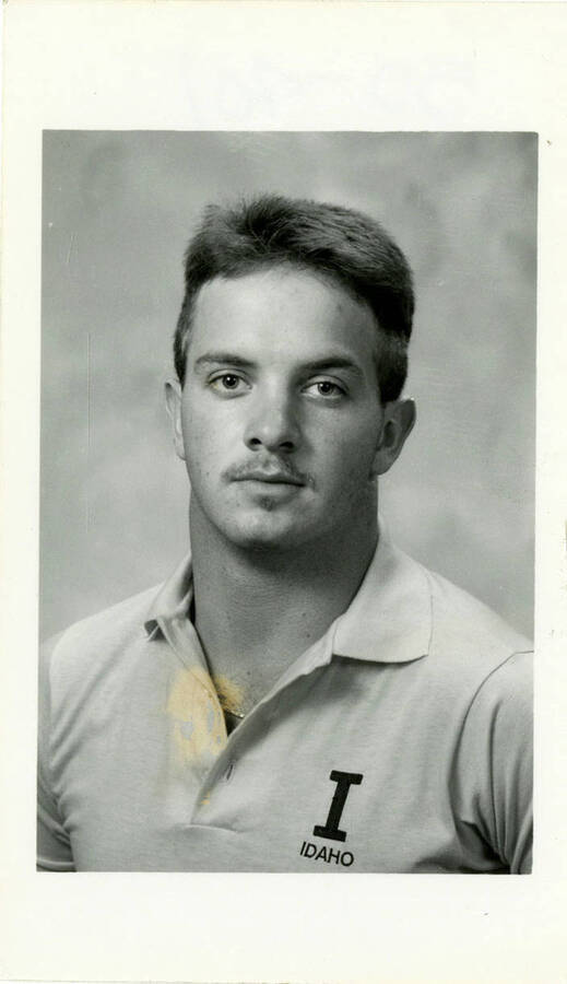 Portrait of Todd Hoiness, Idaho football, wearing an IDAHO collared shirt.