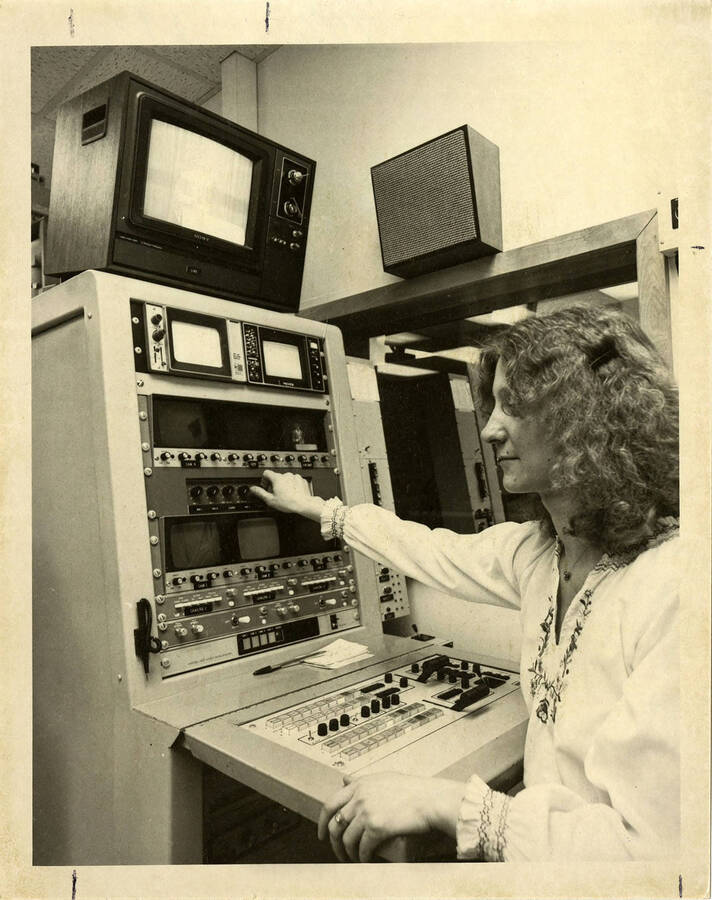 Woman operating possibly film/broadcasting equipment.