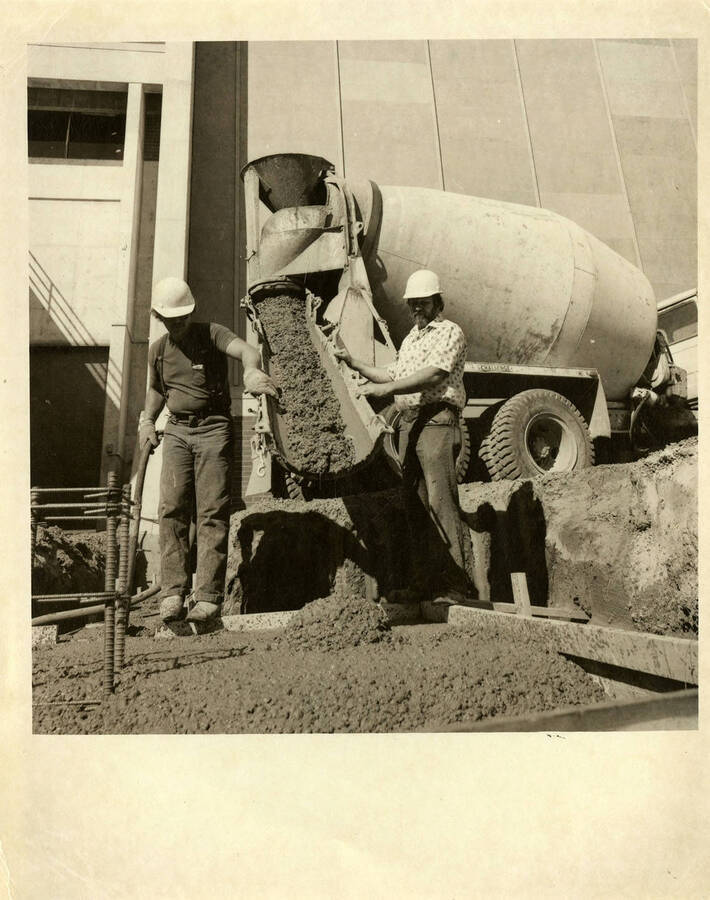 Construction workers pouring concrete for Kibbie Dome annex.