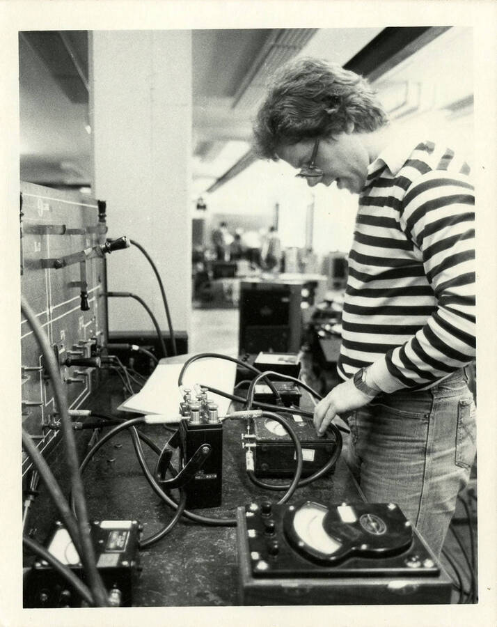 Woman operating some type of scientific equipment.
