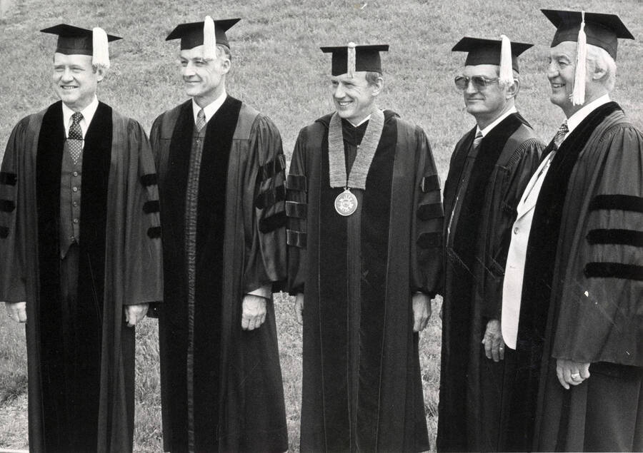 Sen. McClure (left) Hadell (second from left) Pres. Gibb (center) W. Kibbie (right) at an honorary degree ceremony.