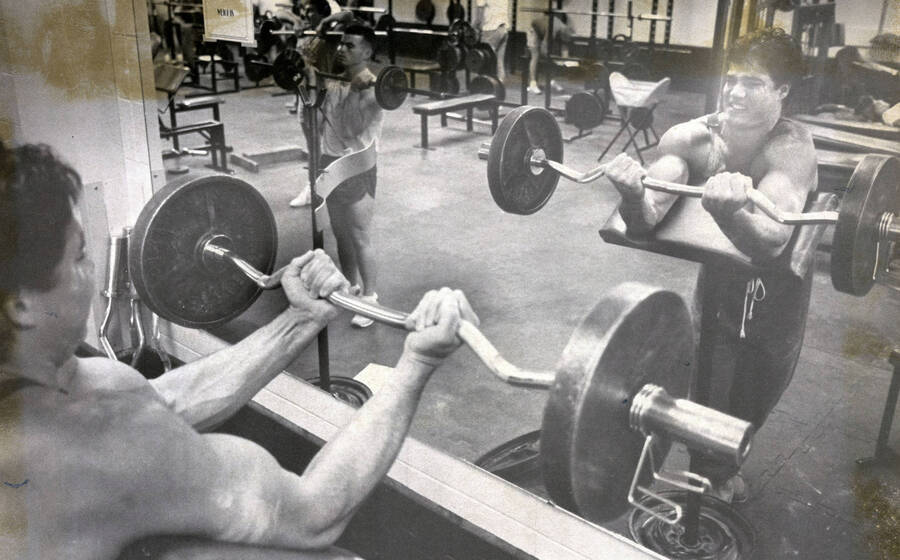 Students lifting weights in a gym.