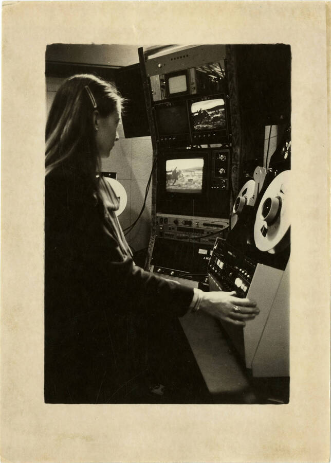 Woman operating video editing equipment.