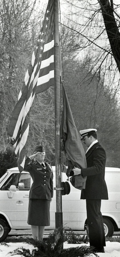 A female soldier salutes the American flag as it raised.