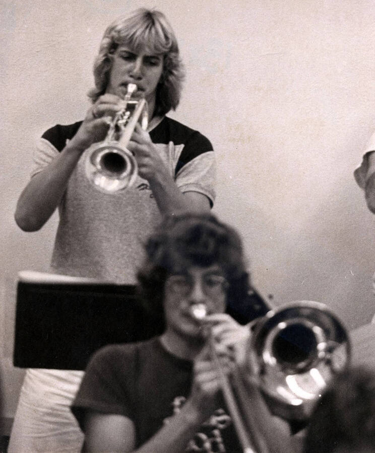 Two trumpet players practicing together.