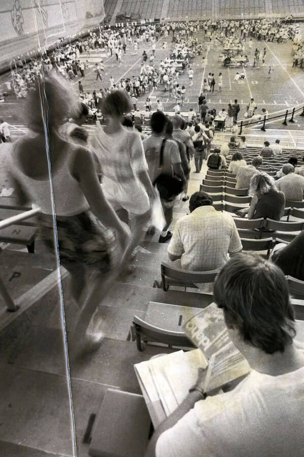 Students filling the Kibbie dome to register for classes on the playing field. Caption:  'The seemingly endless stream of students continued throughout U of I Registration Day as enrollment jumped - students this semester.'
