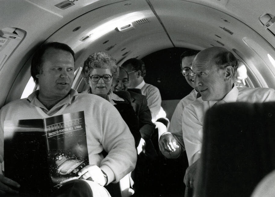 Administrators on an airplane. From left to right: Butch Holden, Karen Keissling, and President Gibb.