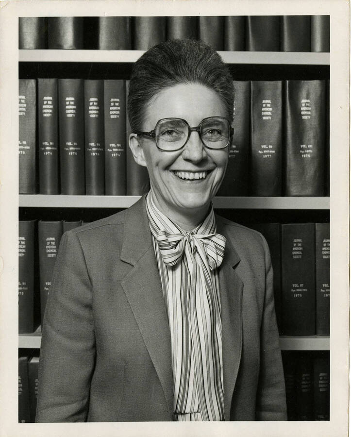 Jean'ne M. Shreeve, Department of Chemistry Professor, smiling in front of a full bookshelf.