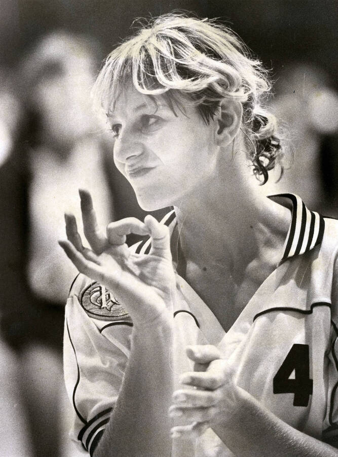 Leslie Christenson giving an ""A-Okay"" hand signal during a volleyball game.