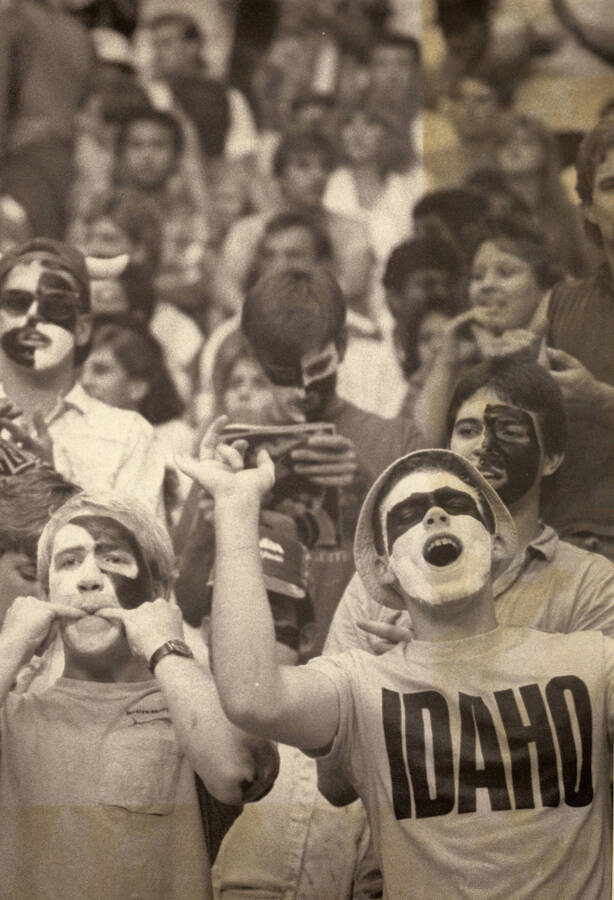 U of I sports fans cheering, some wearing face paint. Sport unknown.