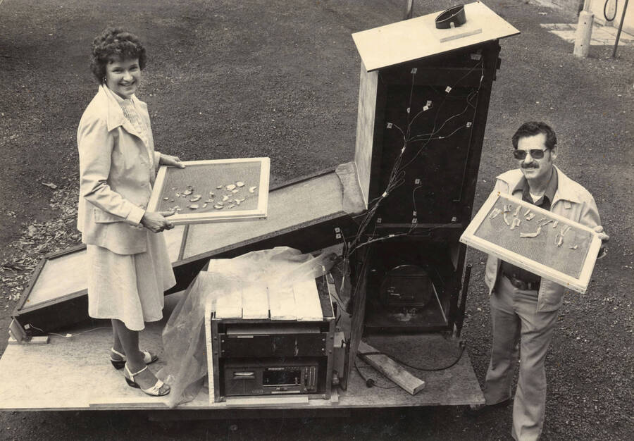 U of I Nutrition Specialist Marilyn Swanson and Ken Hoyt posing with a solar food dryer in the Philippines. Written on the back of the photo is 'PIP in Philippines.' PIP stands for 'Postharvest Institute for Perishables.'