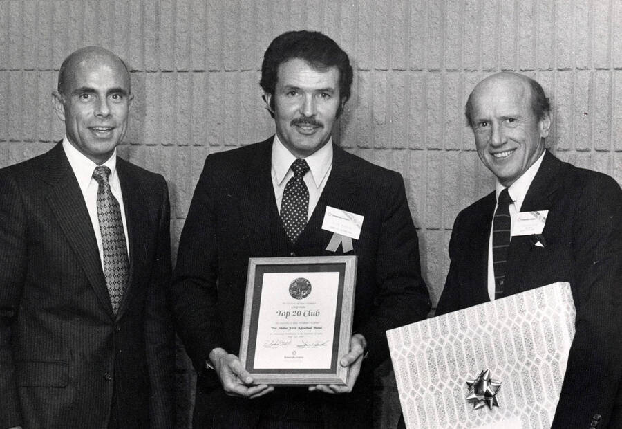 Richard Barton receiving a ""Corporate Top 20"" award from Mr. Hawkins (left) and President Gibb (right) on behalf of Idaho 1st National Bank.