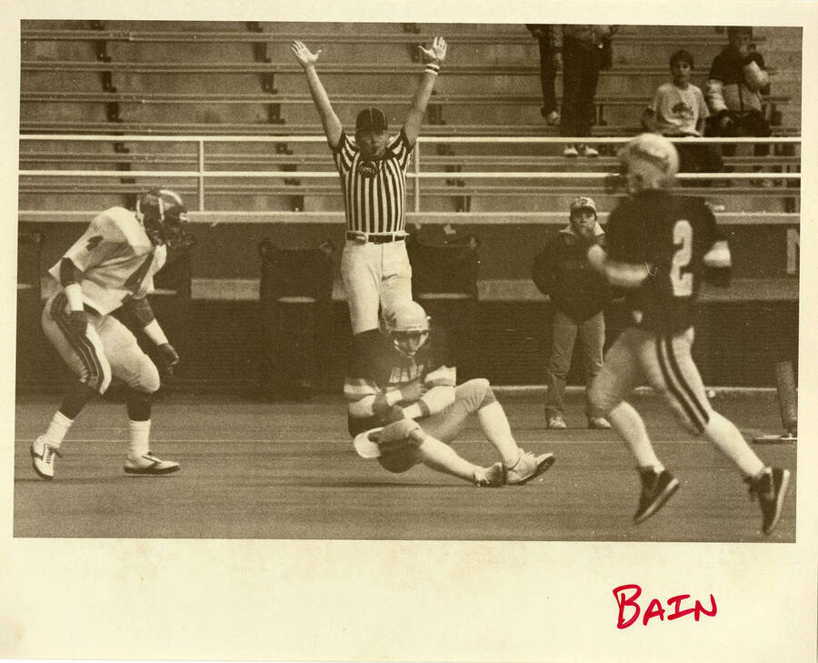 A referee calling an Idaho football team touchdown.