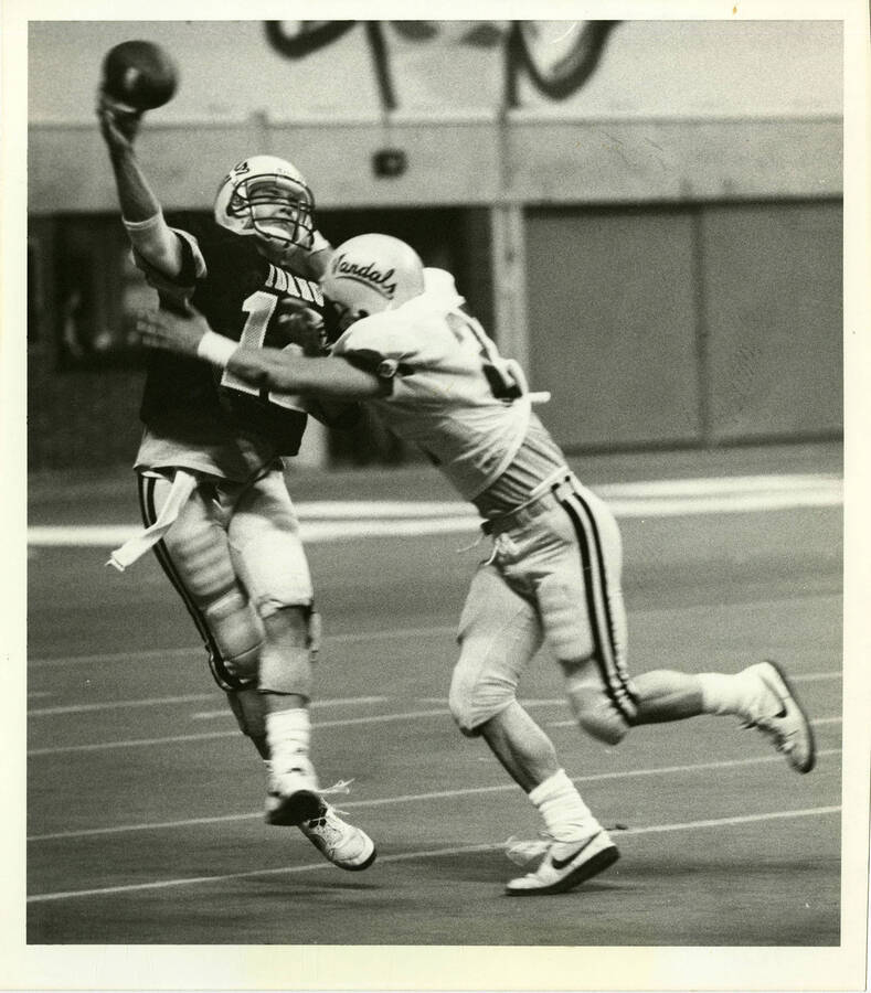 Idaho quarterback Steve Nolan tries to elude a teammate during practice in the Kibbie Dome.