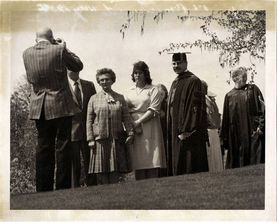 Dean John H. Ehrenreich (right), professor Emeritus of International Forest and Range Resources, poses for a photo with others at the UI Commencement Ceremony in 1984.