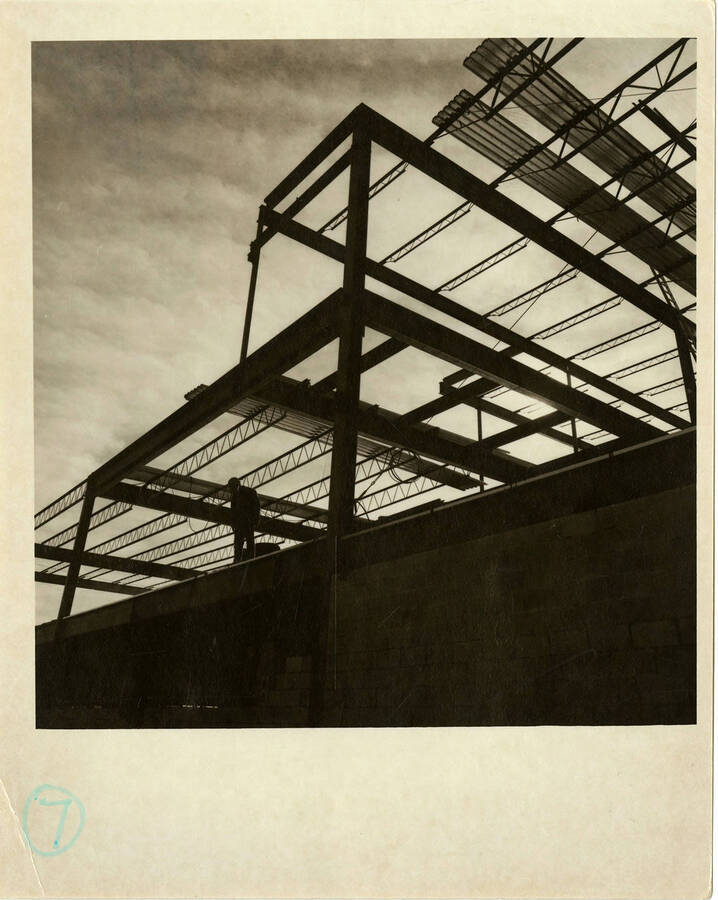Kibbie Dome annex under construction. Man standing on top of the construction.
