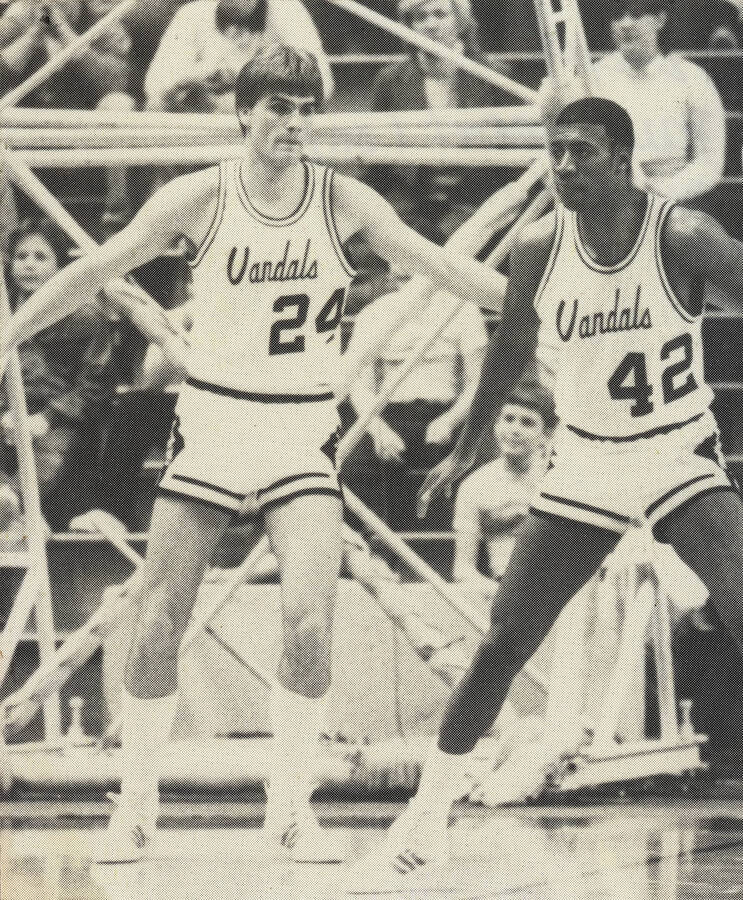 Pete Prigge (24) and Freeman Watkins (42) playing defense during a basketball game.