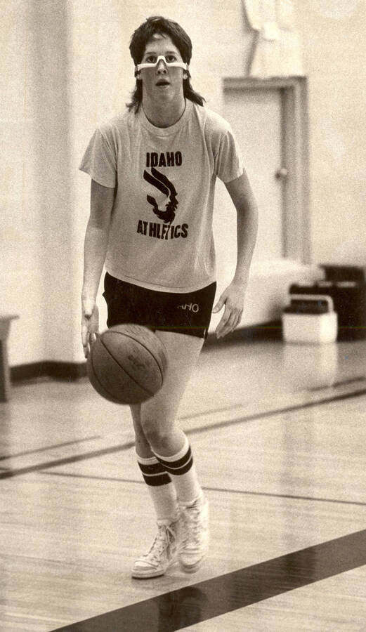 Vandals Women's Basketball player Kris Edmonds at practice, wearing dribble glasses and an Idaho Athletics t-shirt with the old U of I NCAA logo.